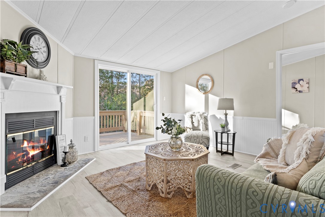 4621 Meherrin Road Meherrin, VA 23954 - Photo 8 of 49 a living room with furniture a fireplace and a large window