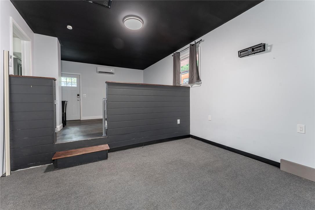 402 Maple Street Roseto, PA 18013 - Photo 30 of 39 Multi-level living spaces connect via short stairs under a bold dark ceiling.