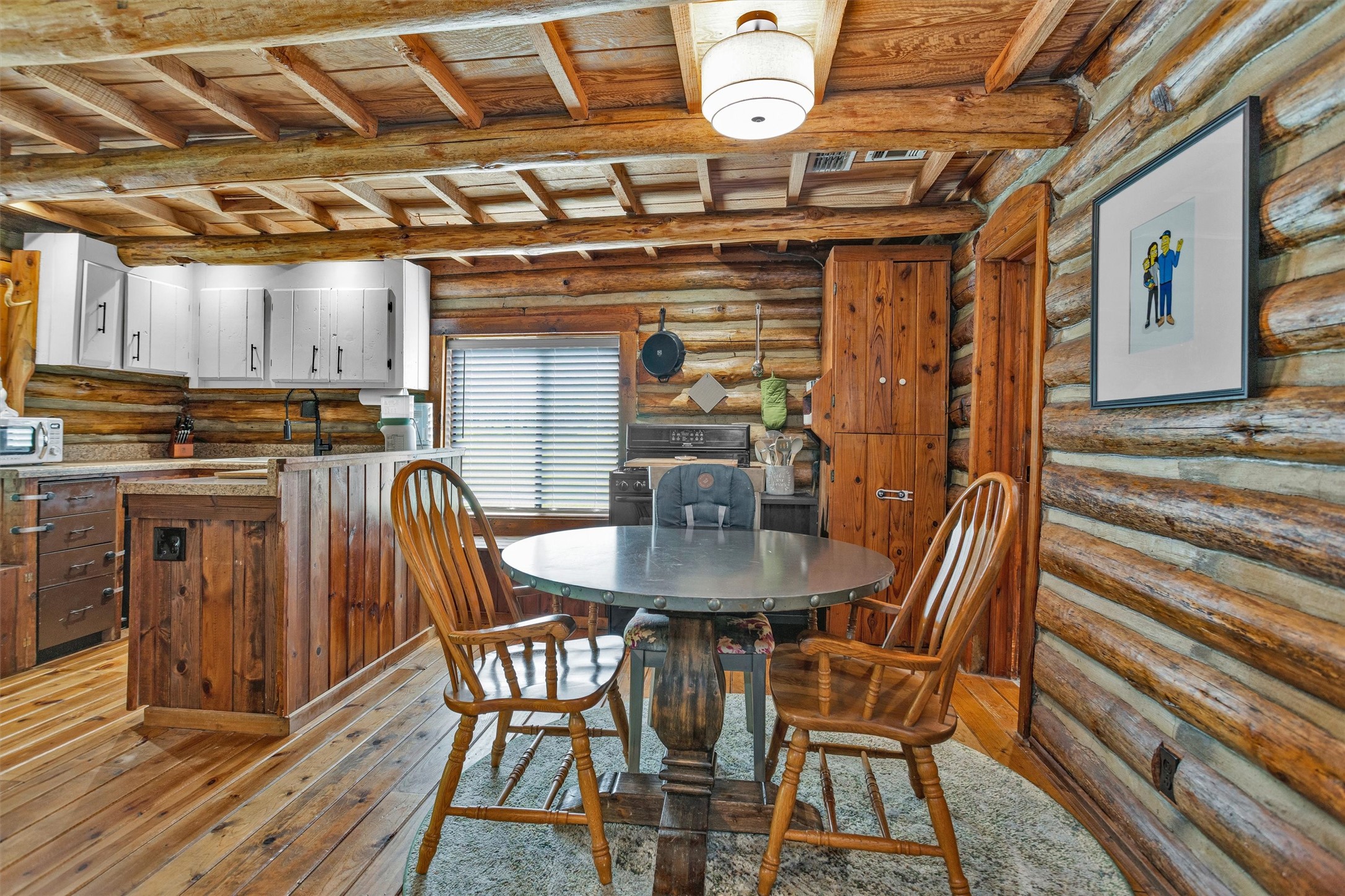 1356 Pegoda Ranch Road Groveton, TX 75845 - Photo 17 of 44 a view of a dining room with furniture and wooden floor