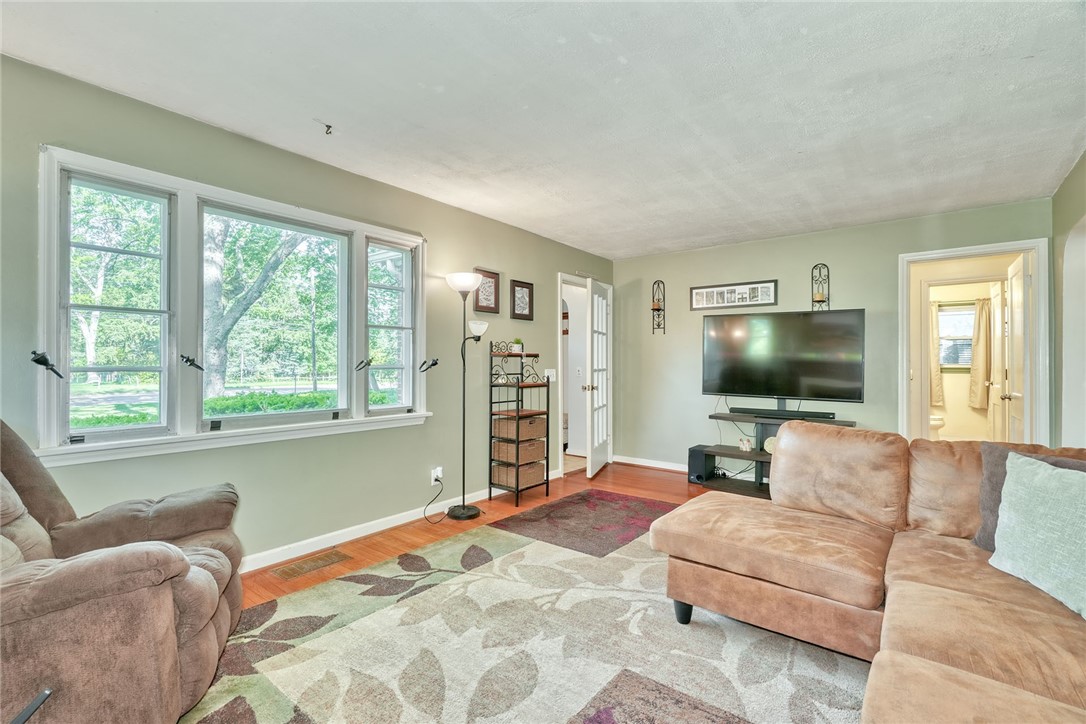 606 Bay Road Webster, NY 14580 - Photo 5 of 49 Family room with hardwood floors, woodburning, fir