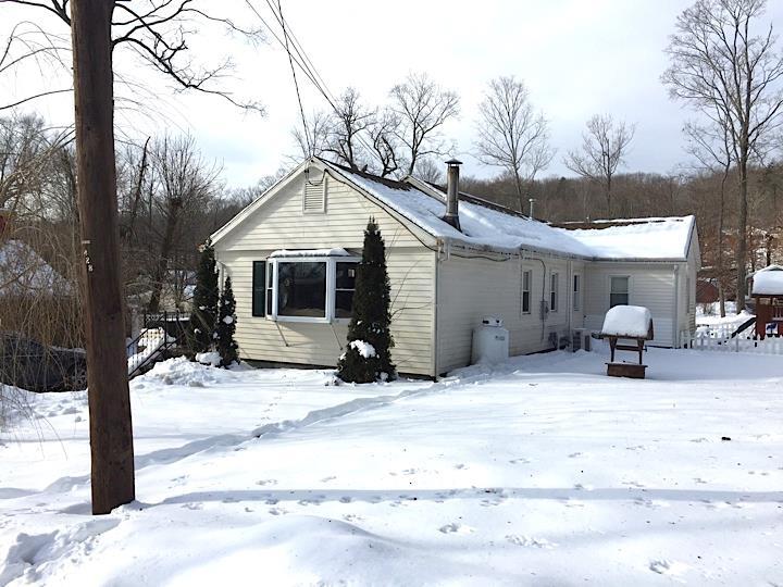 a view of a house with snow in the yard