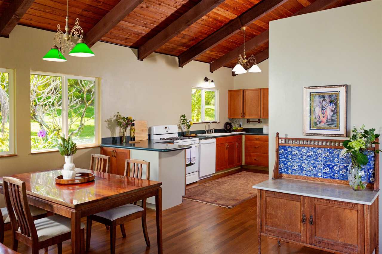 245 North Honokala Road Haiku, HI 96708 - Photo 2 of 17 a open dining room with stainless steel appliances kitchen island granite countertop a table chairs and a wooden floor