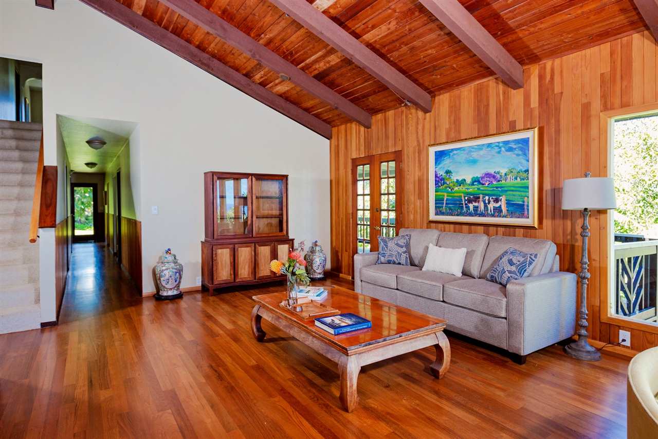 245 North Honokala Road Haiku, HI 96708 - Photo 3 of 17 a living room with furniture a wooden floor and next to a window