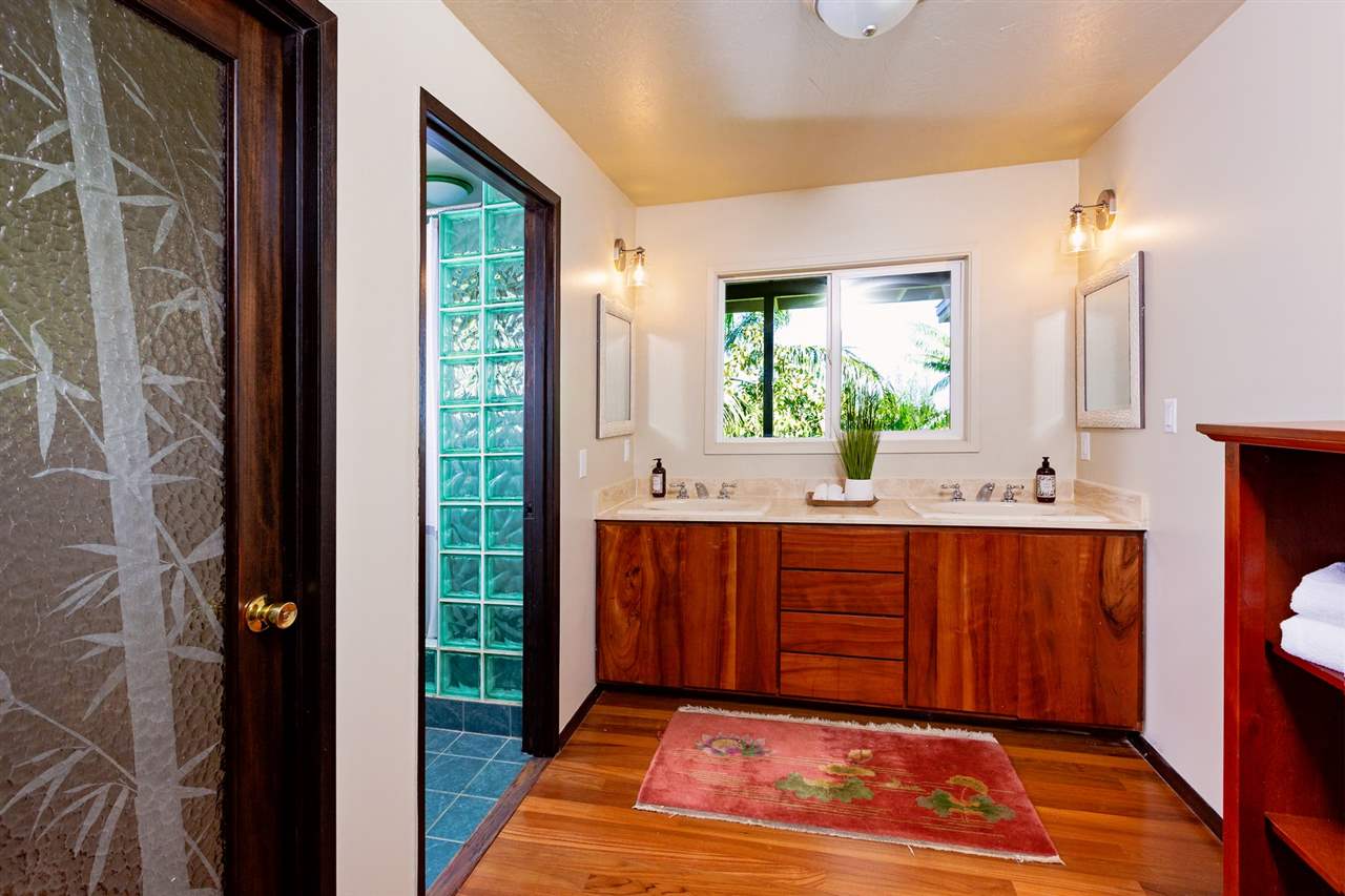 245 North Honokala Road Haiku, HI 96708 - Photo 6 of 17 a spacious bathroom with a double vanity sink a mirror and a shower