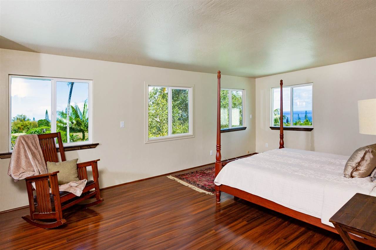 245 North Honokala Road Haiku, HI 96708 - Photo 7 of 17 a bedroom with a bed and windows