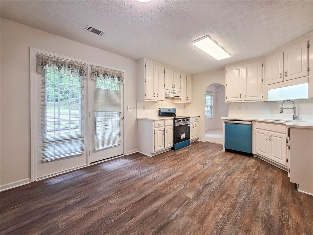 355 Austin Way Auburn, GA 30011 - Photo 11 of 19 a kitchen with stainless steel appliances a stove top oven and a refrigerator