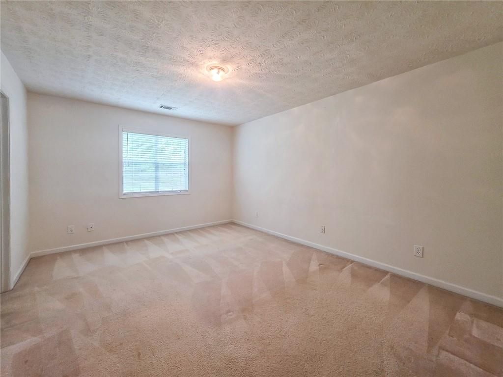 355 Austin Way Auburn, GA 30011 - Photo 13 of 19 an empty room with a window