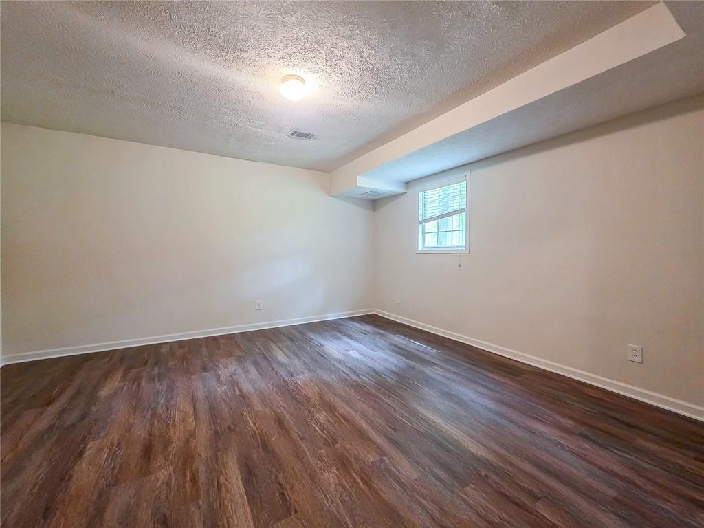 355 Austin Way Auburn, GA 30011 - Photo 15 of 19 an empty room with wooden floor and windows