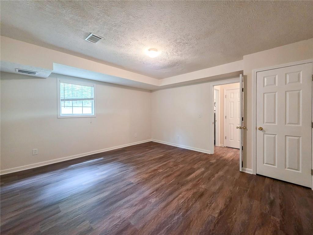 355 Austin Way Auburn, GA 30011 - Photo 17 of 19 an empty room with wooden floor and windows