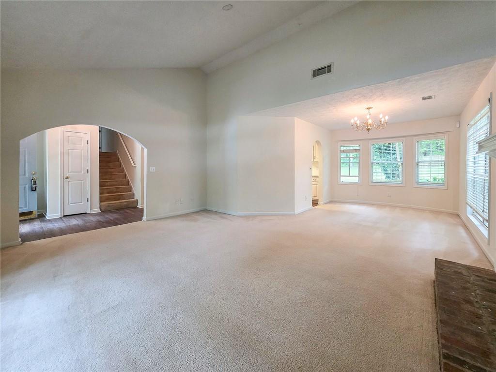 355 Austin Way Auburn, GA 30011 - Photo 6 of 19 a view of an empty room with a fireplace and windows