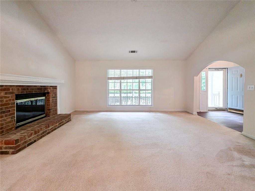 355 Austin Way Auburn, GA 30011 - Photo 8 of 19 an empty room with windows and fireplace