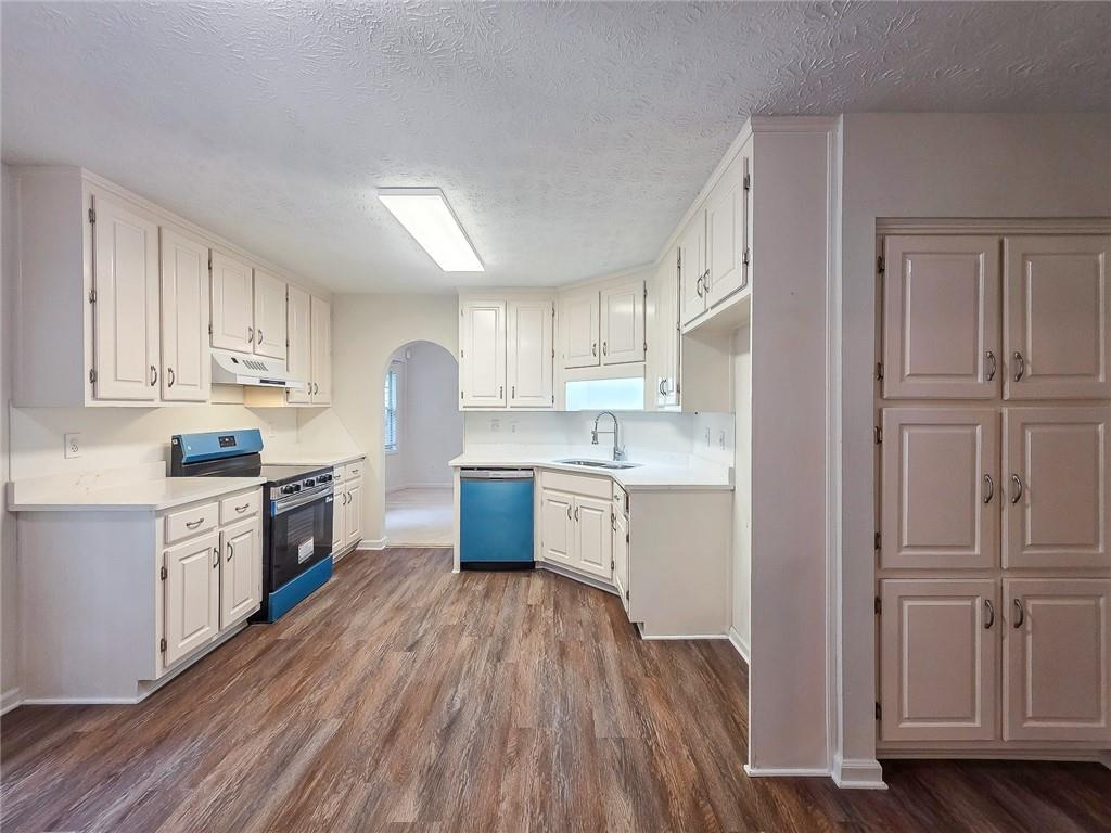 355 Austin Way Auburn, GA 30011 - Photo 9 of 19 a kitchen with granite countertop white cabinets and white appliances