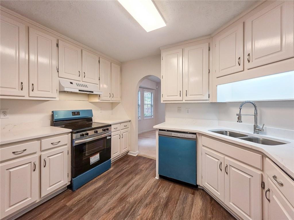 355 Austin Way Auburn, GA 30011 - Photo 10 of 19 a kitchen with granite countertop white cabinets and white appliances