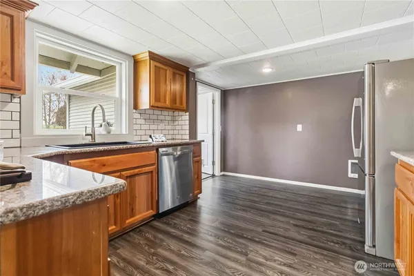 a kitchen with stainless steel appliances granite countertop a sink and a stove