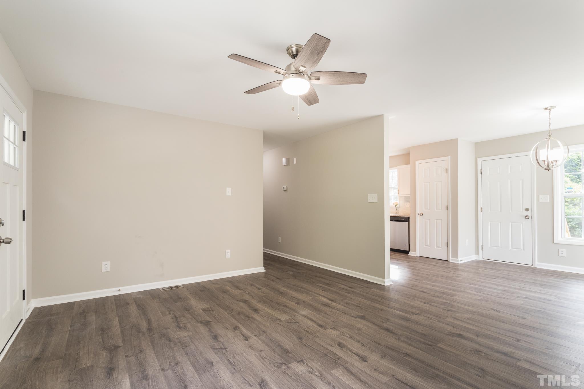 1807 South Roxboro Street Durham, NC 27707 - Photo 11 of 27 an empty room with wooden floor and a ceiling fan