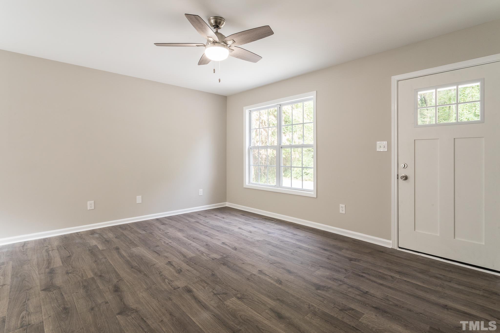 1807 South Roxboro Street Durham, NC 27707 - Photo 13 of 27 an empty room with wooden floor ceiling fan and windows