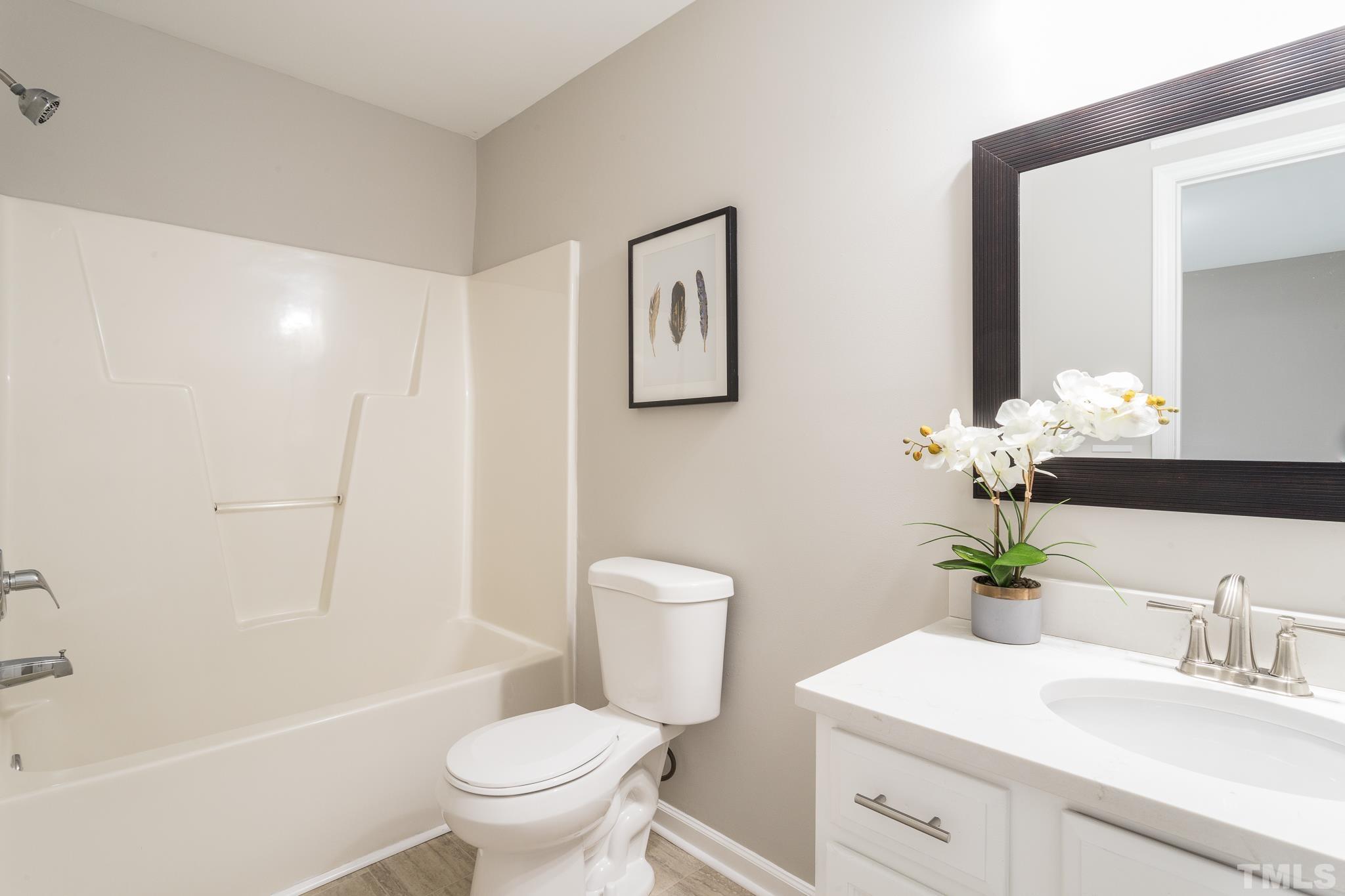 1807 South Roxboro Street Durham, NC 27707 - Photo 17 of 27 a bathroom with a sink a toilet and a large mirror