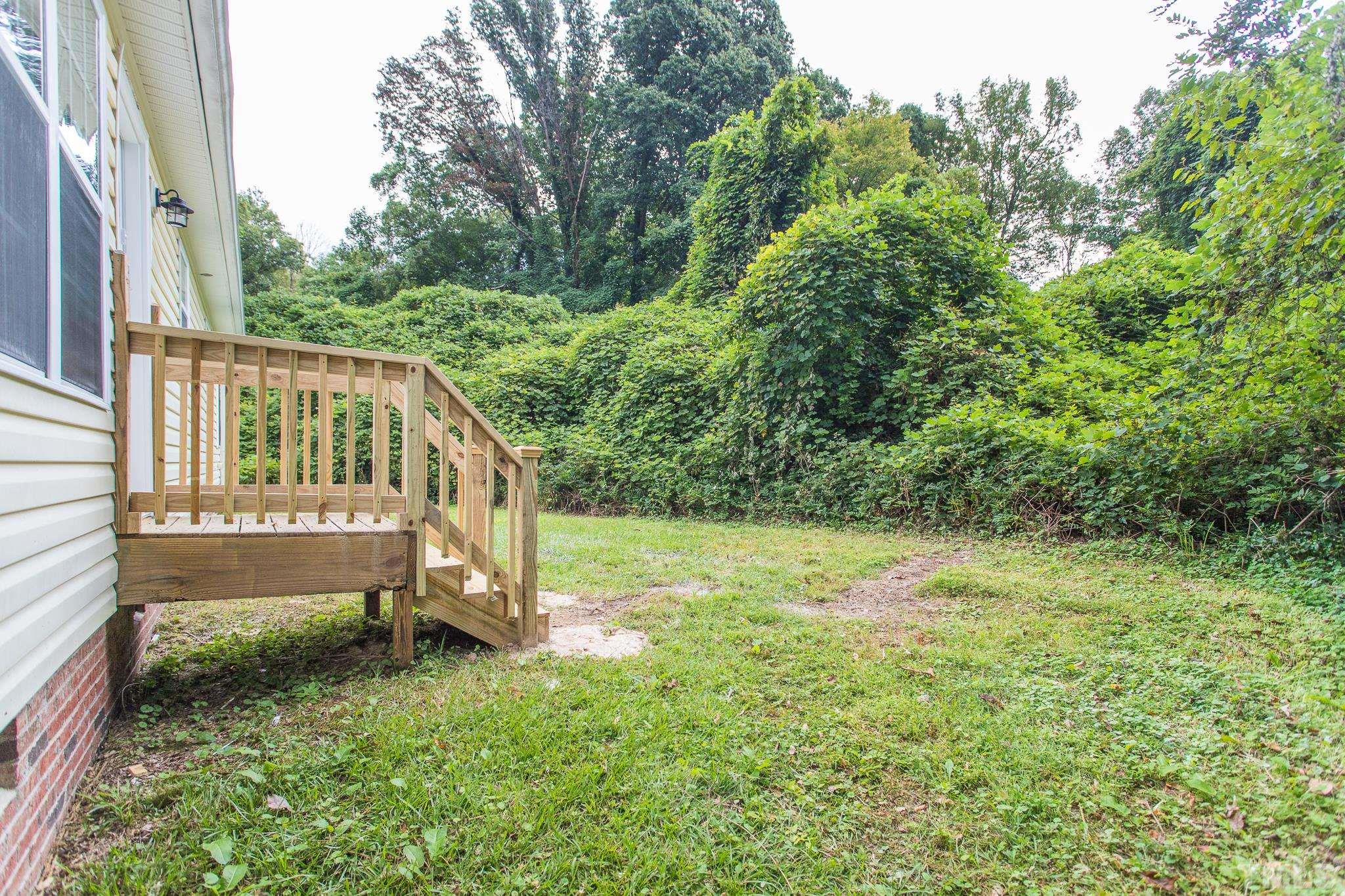 1807 South Roxboro Street Durham, NC 27707 - Photo 26 of 27 a view of a yard with a house and wooden fence