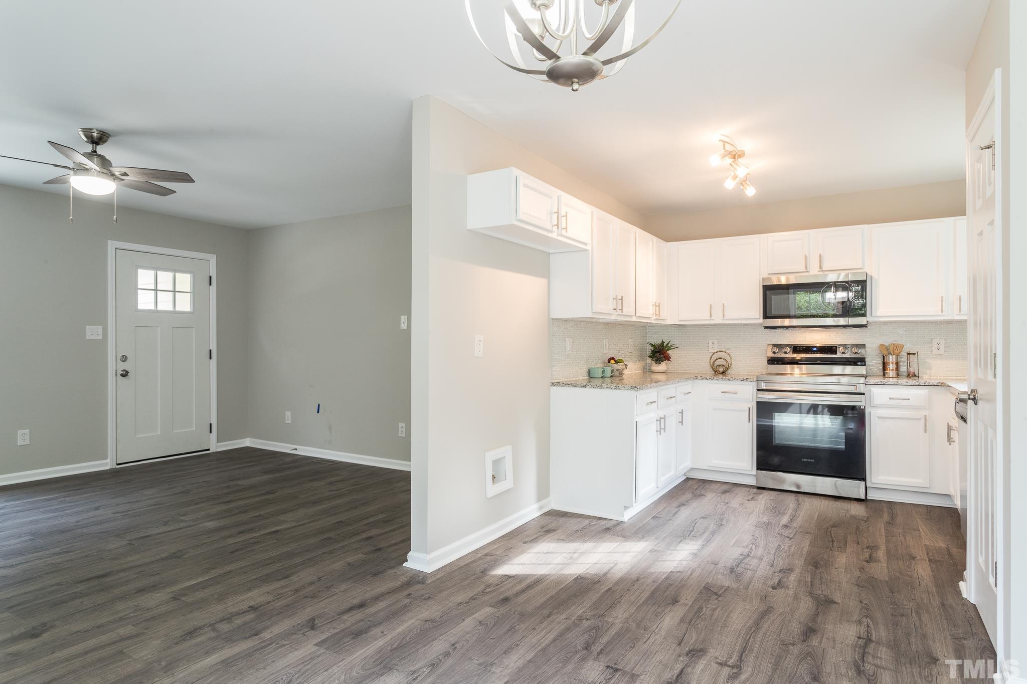 1807 South Roxboro Street Durham, NC 27707 - Photo 4 of 27 a kitchen with granite countertop a refrigerator and a stove top oven