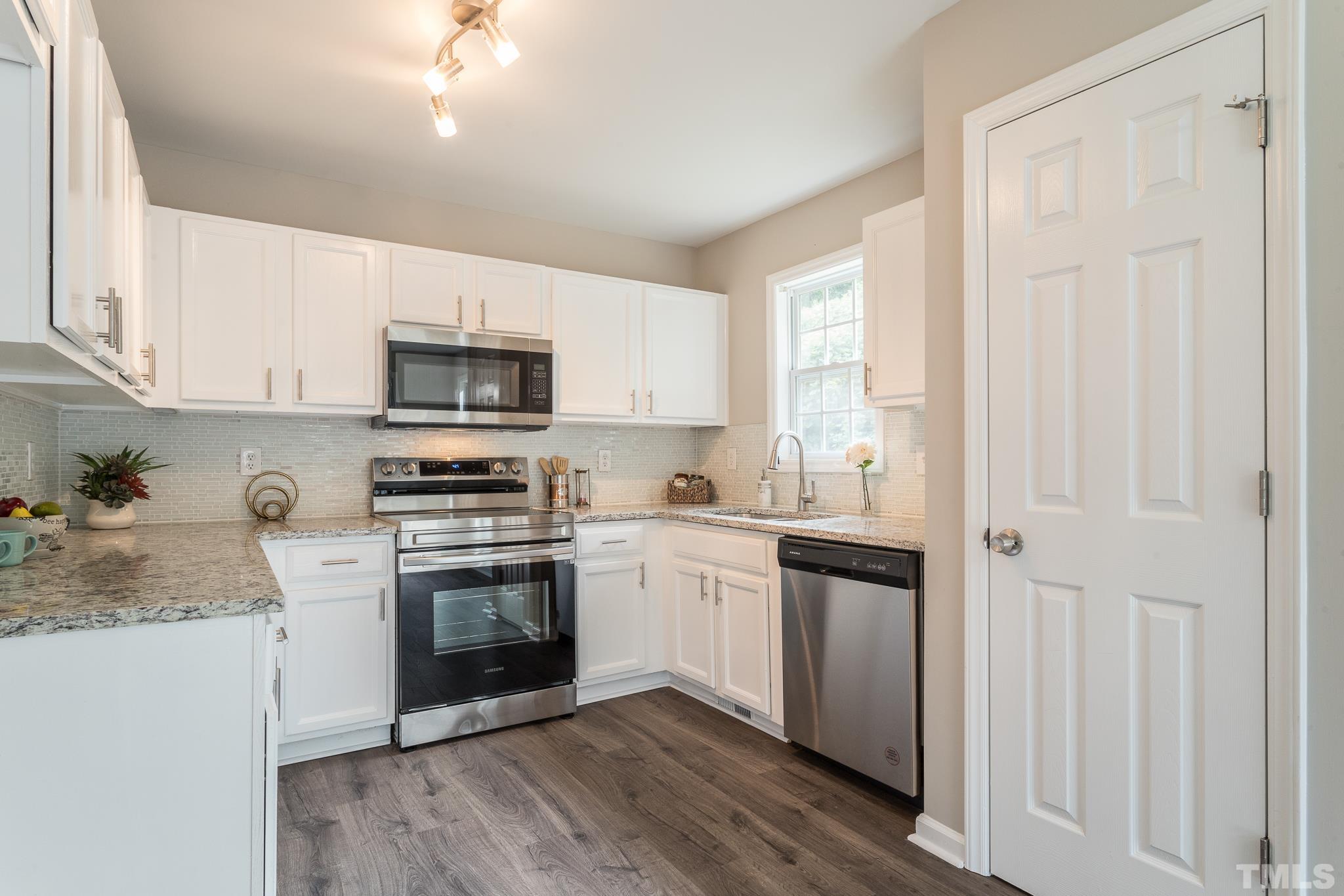 1807 South Roxboro Street Durham, NC 27707 - Photo 6 of 27 a kitchen with a stove a sink and a microwave