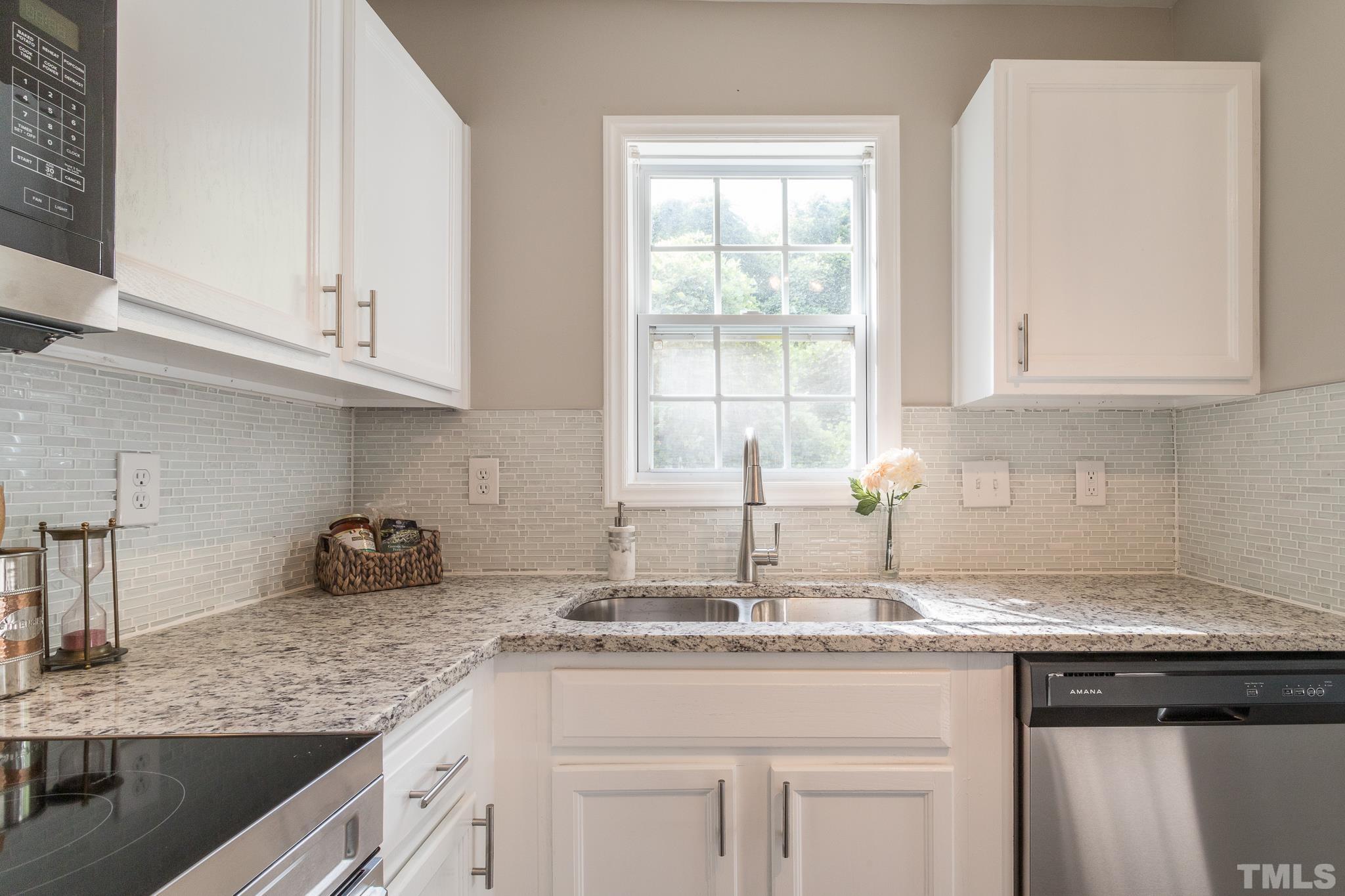 1807 South Roxboro Street Durham, NC 27707 - Photo 7 of 27 a kitchen with granite countertop white cabinets and a sink