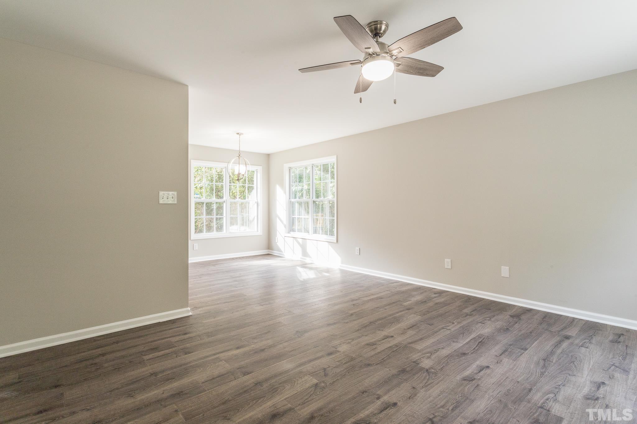 1807 South Roxboro Street Durham, NC 27707 - Photo 10 of 27 an empty room with wooden floor and ceiling fan