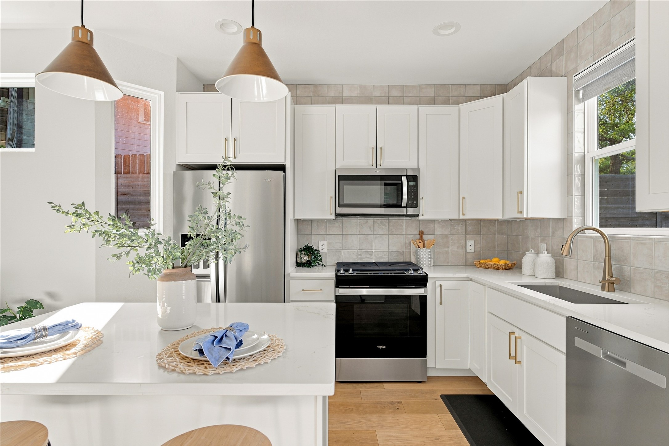5506 Hudson Street, Unit 2 Austin, TX 78721 - Photo 1 of 24 Quartz countertops and stainless-steel appliances anchor this light-filled modern kitchen.
