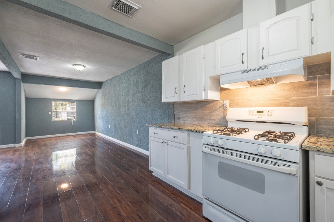 715 Center Street Pasadena, TX 77506 - Photo 12 of 33 a kitchen with a stove a sink and a refrigerator