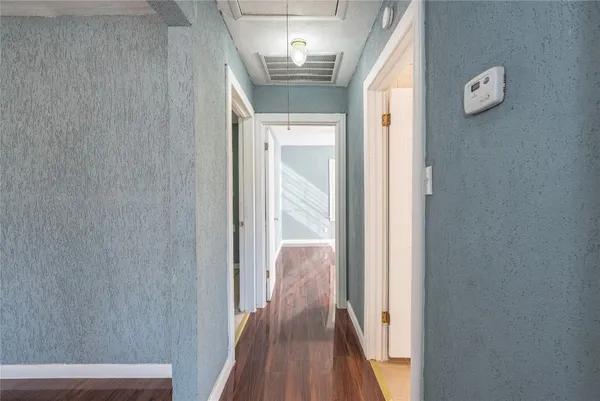 a view of hallway with wooden floor