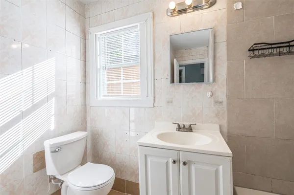 a bathroom with a sink a toilet and a mirror