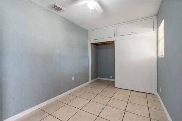 a view of walk in closet with empty room
