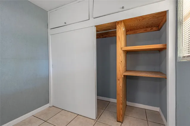 a view of walk in closet with empty room