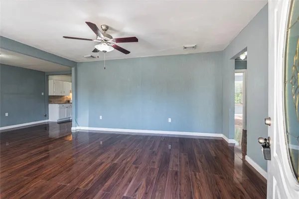 wooden floor in an empty room with a window