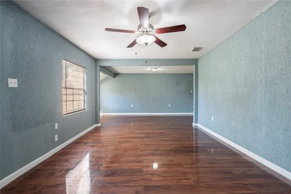 wooden floor in an empty room with a window