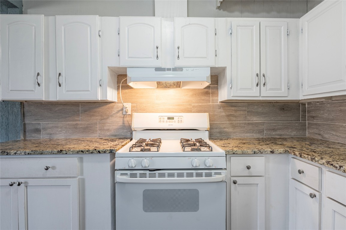 715 Center Street Pasadena, TX 77506 - Photo 10 of 33 a kitchen with granite countertop white cabinets and white stove