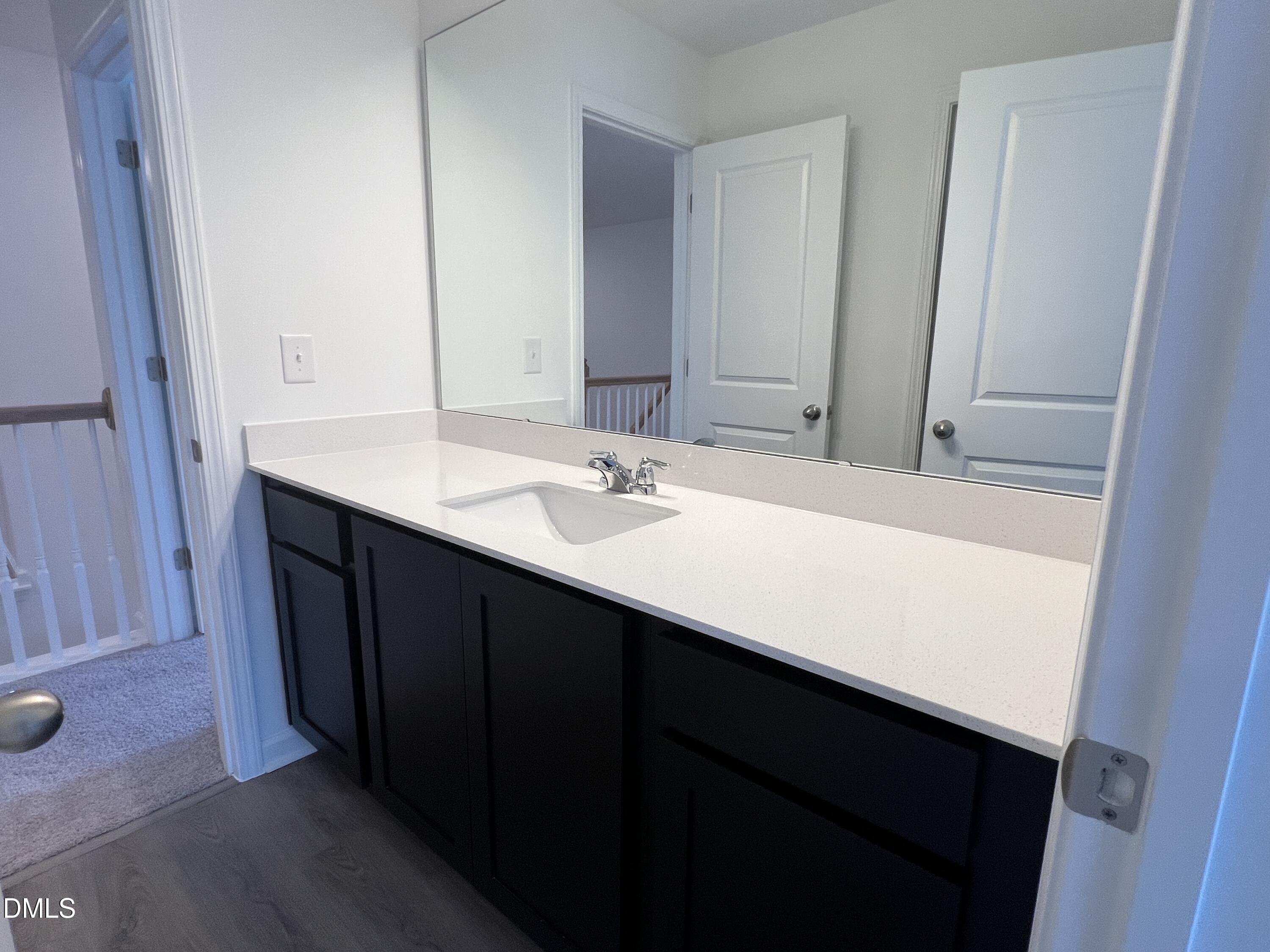 2017 Regal Drive Durham, NC 27703 - Photo 19 of 28 a bathroom with a sink and a mirror