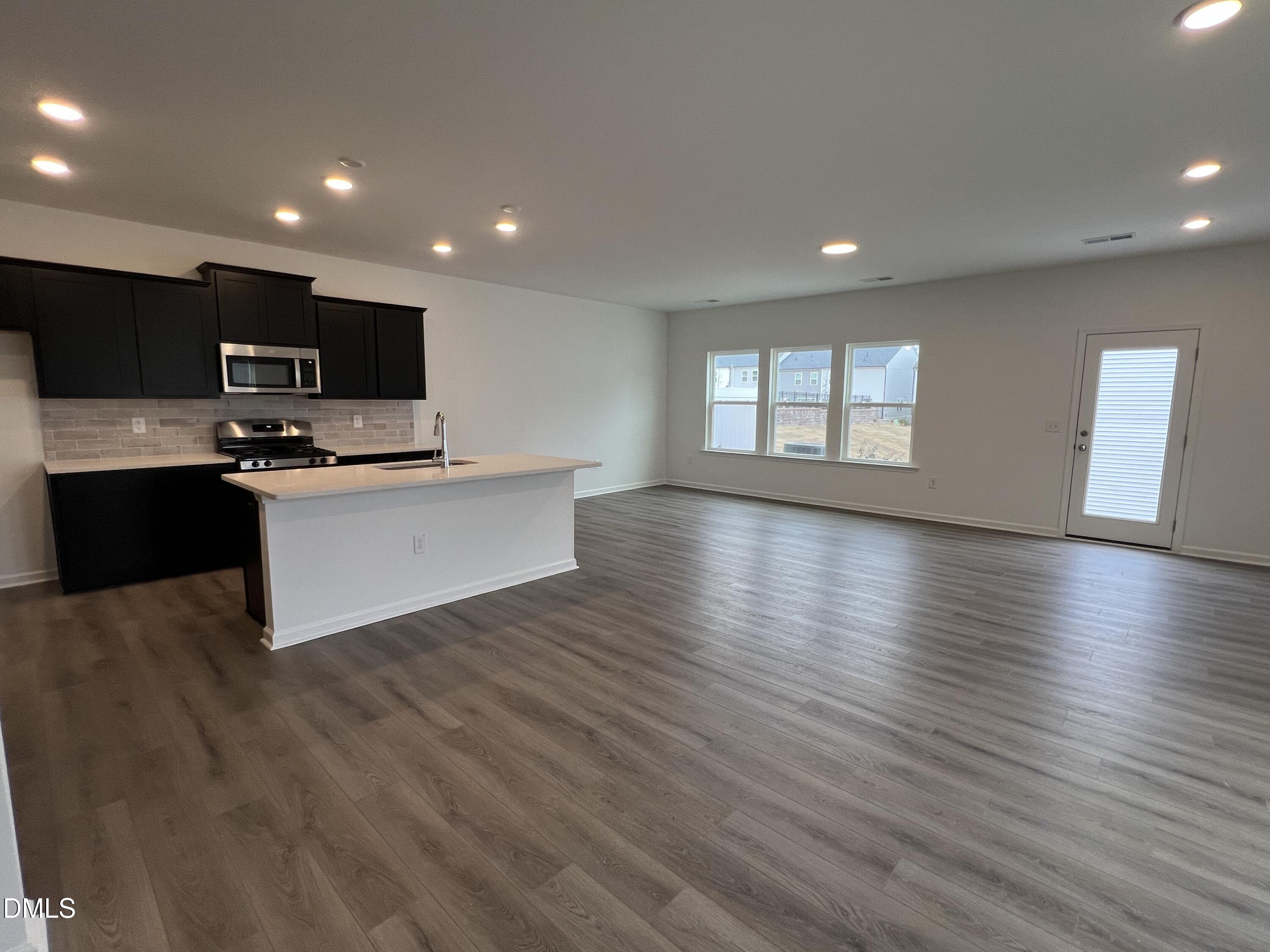 2017 Regal Drive Durham, NC 27703 - Photo 4 of 28 a view of kitchen with microwave a stove and wooden floor