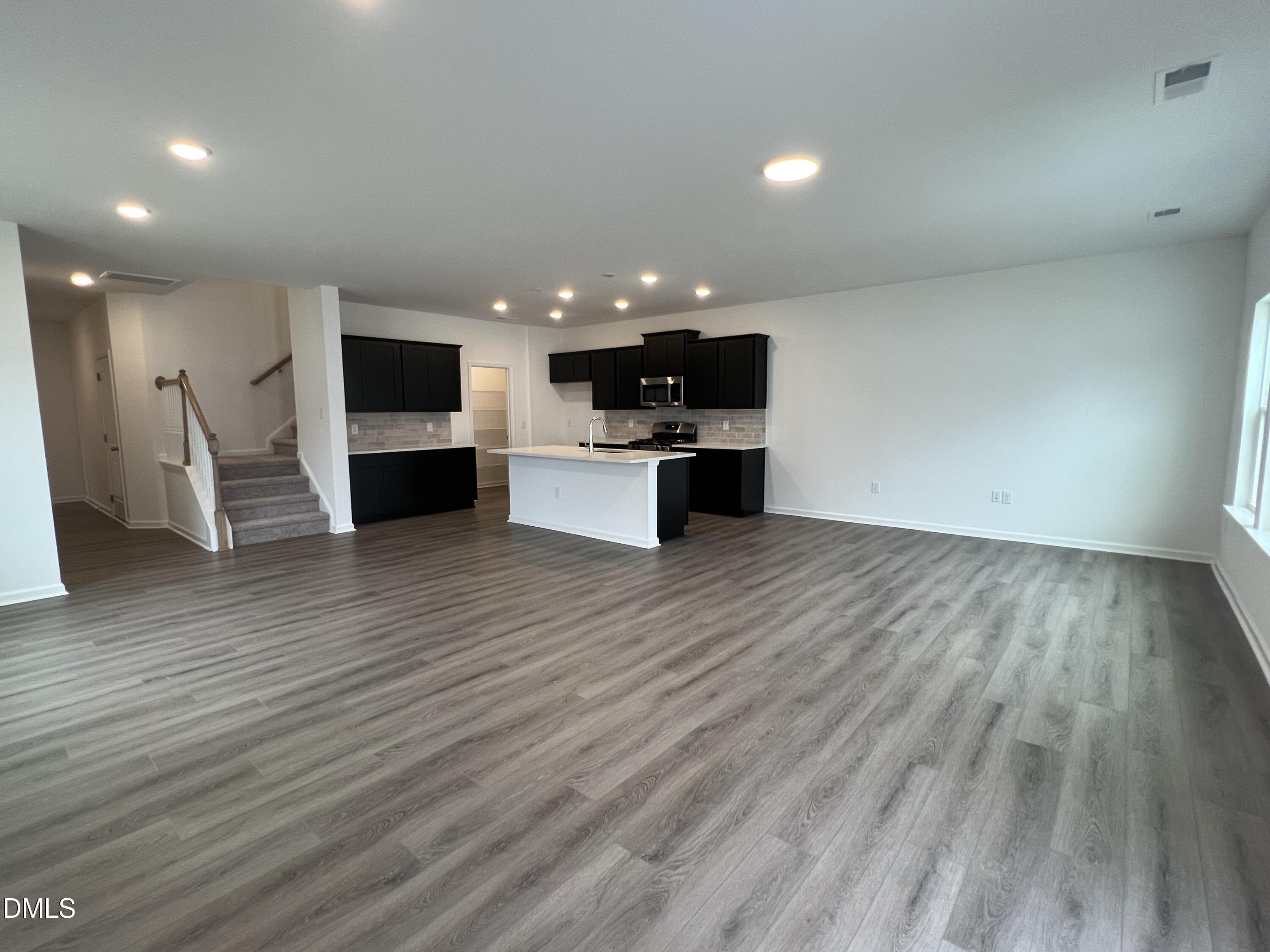 2017 Regal Drive Durham, NC 27703 - Photo 5 of 28 a view of kitchen with microwave a stove and wooden floor