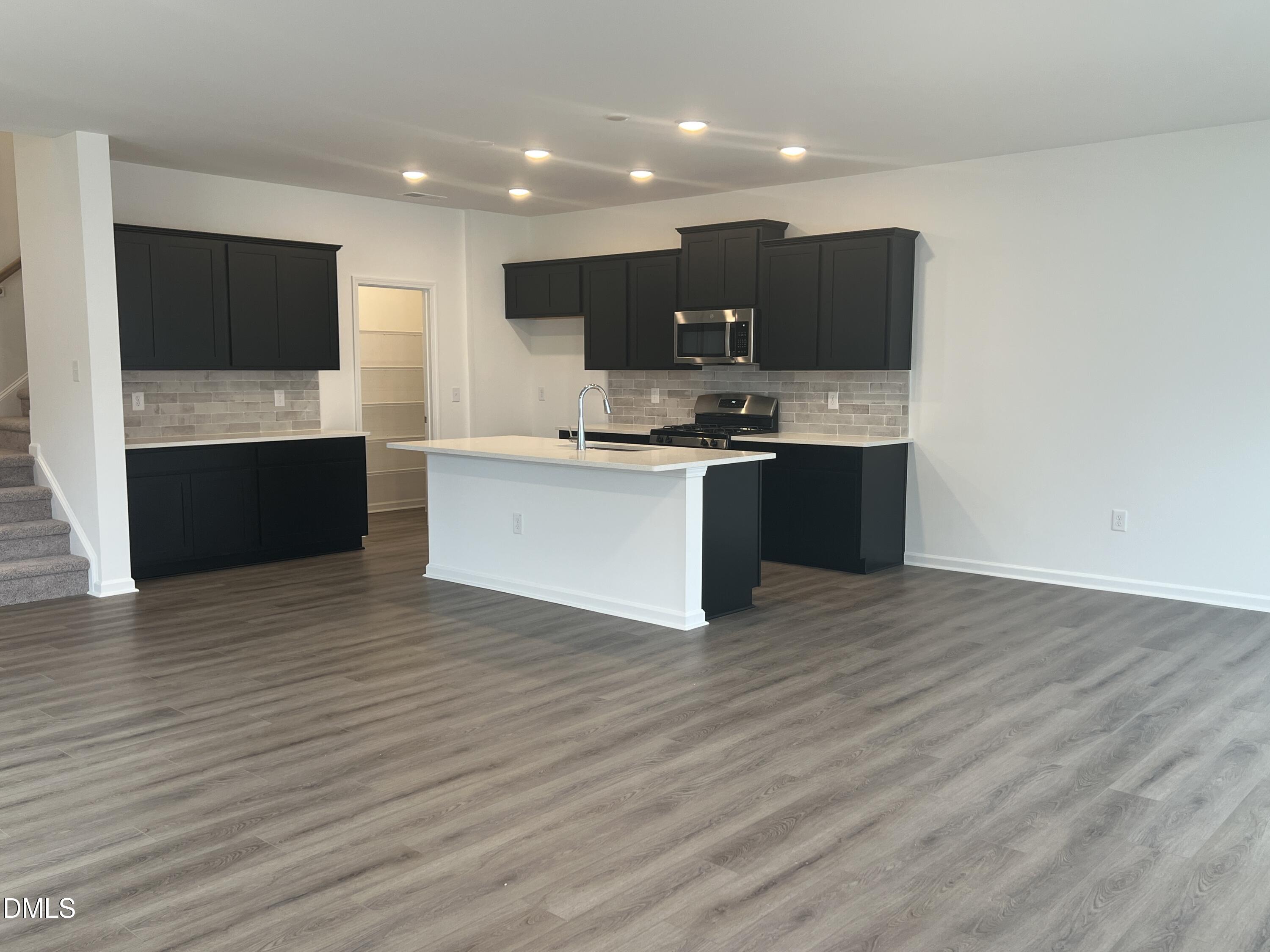 2017 Regal Drive Durham, NC 27703 - Photo 6 of 28 a large kitchen with stainless steel appliances kitchen island a large counter top and a wooden floor