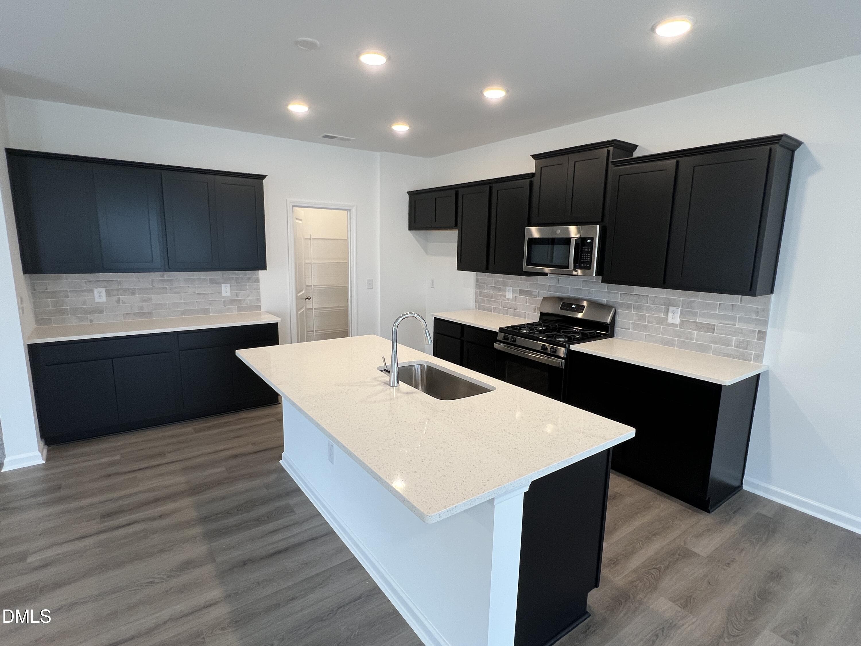 2017 Regal Drive Durham, NC 27703 - Photo 8 of 28 a kitchen with stainless steel appliances a refrigerator and a stove top oven