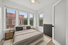 6977 North Bell Avenue, Unit 3 Chicago, IL 60645 - Photo 8 of 15 a bedroom with a large bed and a large window