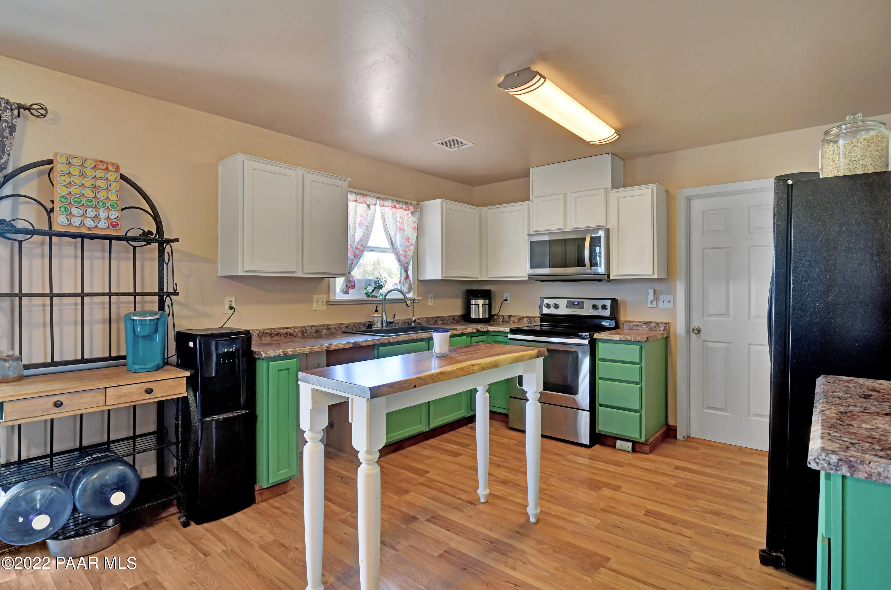 25820 Poppy Road Paulden, AZ 86334 - Photo 11 of 28 a kitchen with a refrigerator a stove a microwave and wooden floor