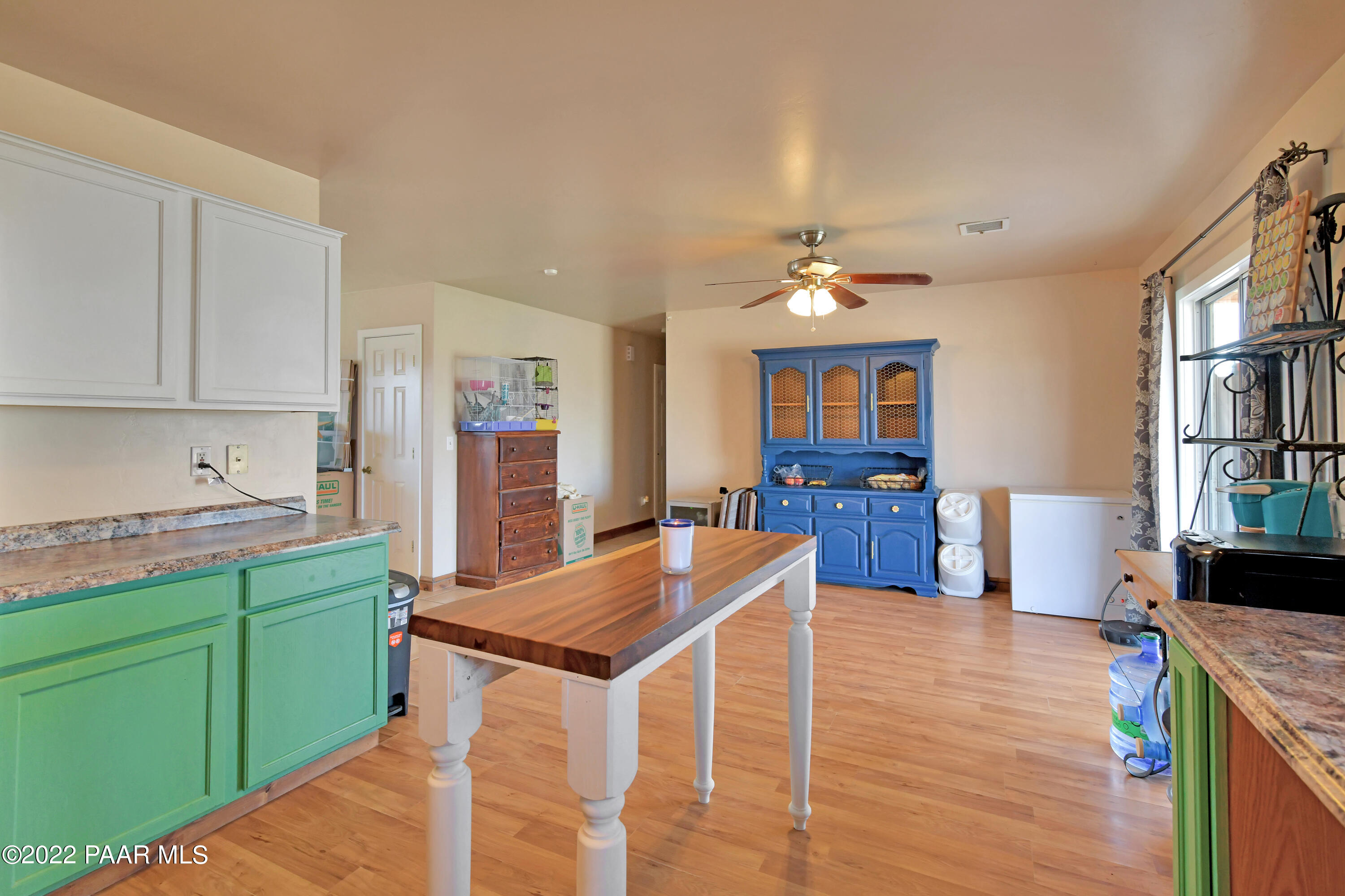 25820 Poppy Road Paulden, AZ 86334 - Photo 12 of 28 a view of a kitchen with kitchen island a sink wooden floor and a large window
