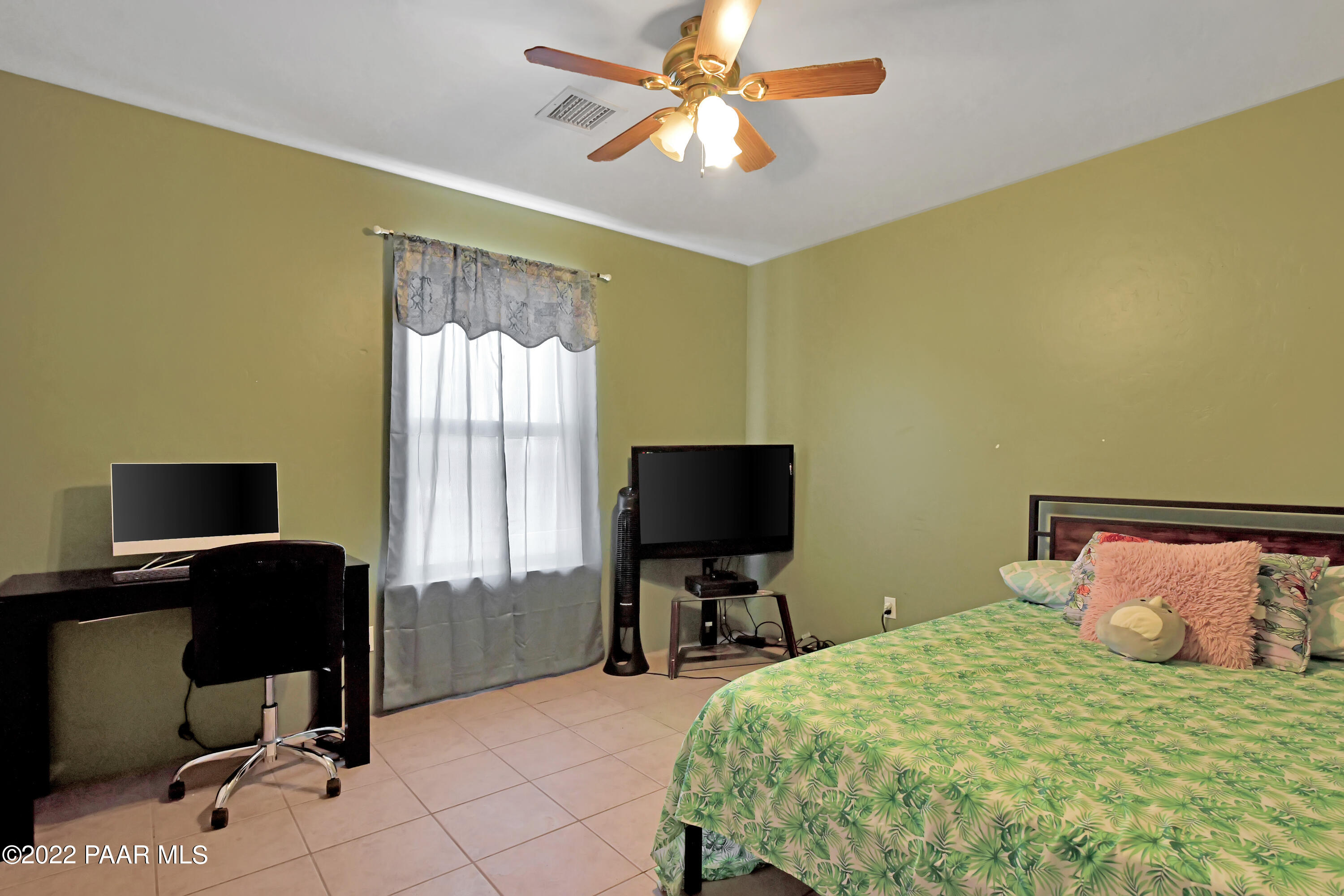 25820 Poppy Road Paulden, AZ 86334 - Photo 19 of 28 a bedroom with a bed window and a flat screen tv