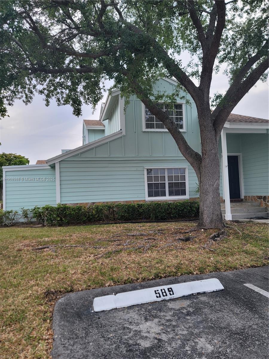 13792 Southwest 149th Cir Lane, Unit 3 Miami, FL 33186 - Photo 2 of 7 a front view of a house with garden
