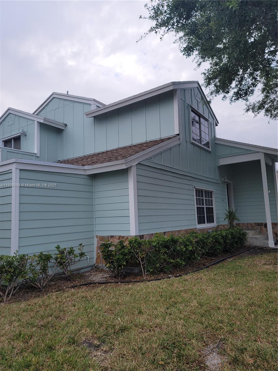 13792 Southwest 149th Cir Lane, Unit 3 Miami, FL 33186 - Photo 4 of 7 a front view of a house with garden