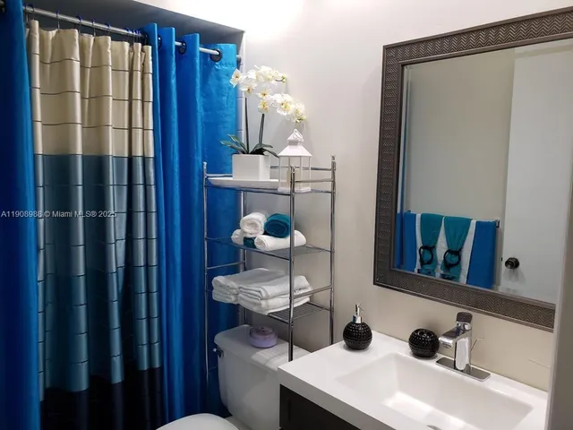 a bathroom with a toilet a sink and vanity