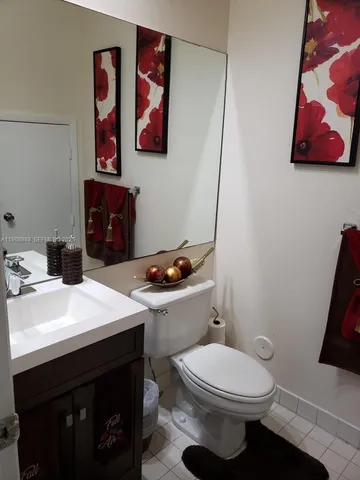 a bathroom with a toilet a sink and vanity