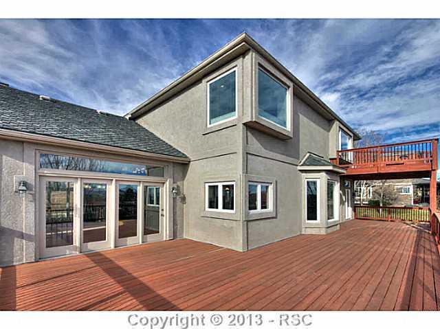 5905 Wilson Road Colorado Springs, CO 80919 - Photo 7 of 25 Formal Dining Room Walks out to Expansive Wood Deck From Which to Enjoy Panoramic City Views