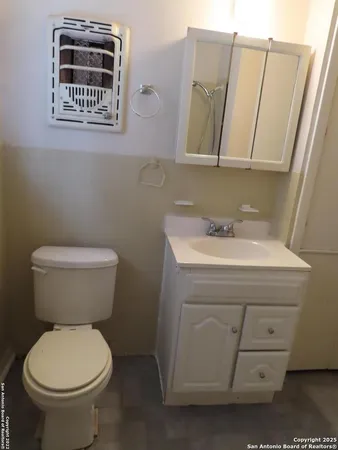 a bathroom with a sink a toilet and mirror
